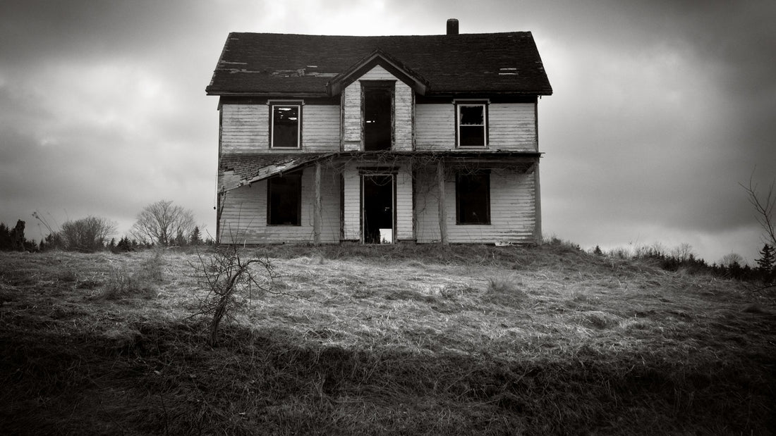 Black and White Photo of a Creepy House on a Hill